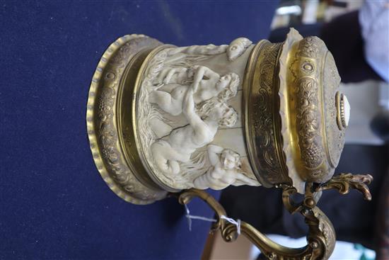 A 19th century German ormolu mounted ivory tankard, carved in relief with a frieze of tritons and nude bathers